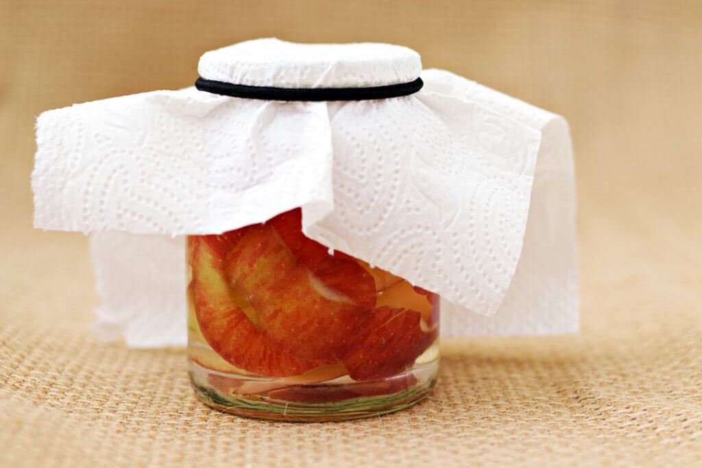 Apple cider vinegar covered with cloth